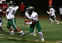 Cross Keys quarterback Christian Holmes looks for running room against the Stone Mountain Pirates